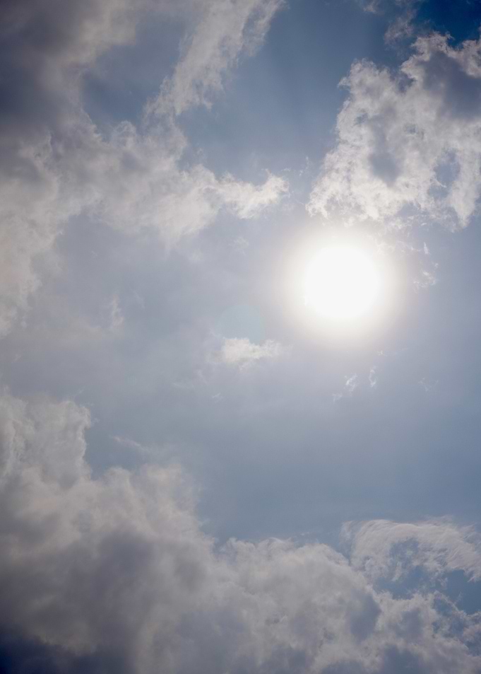 Sun and Clouds in Blue Sky