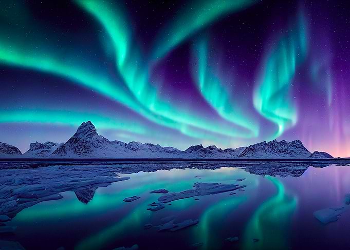Aurora Borealis over Snowy Mountains