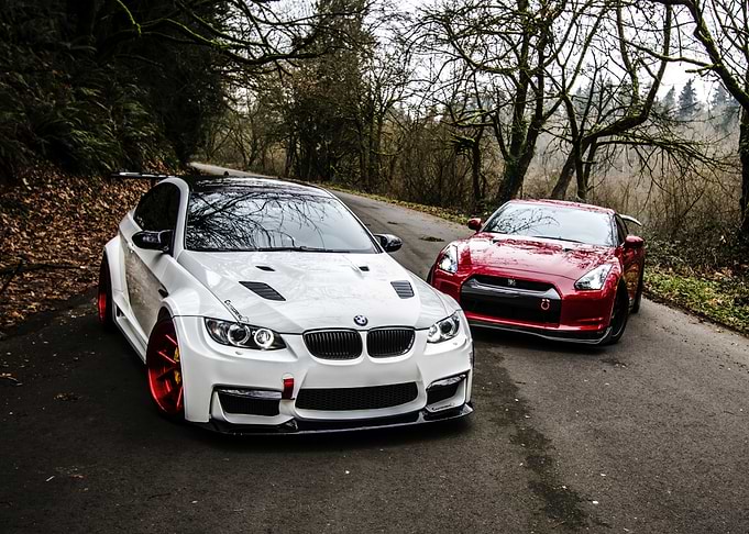 BMW and Nissan sports cars on road