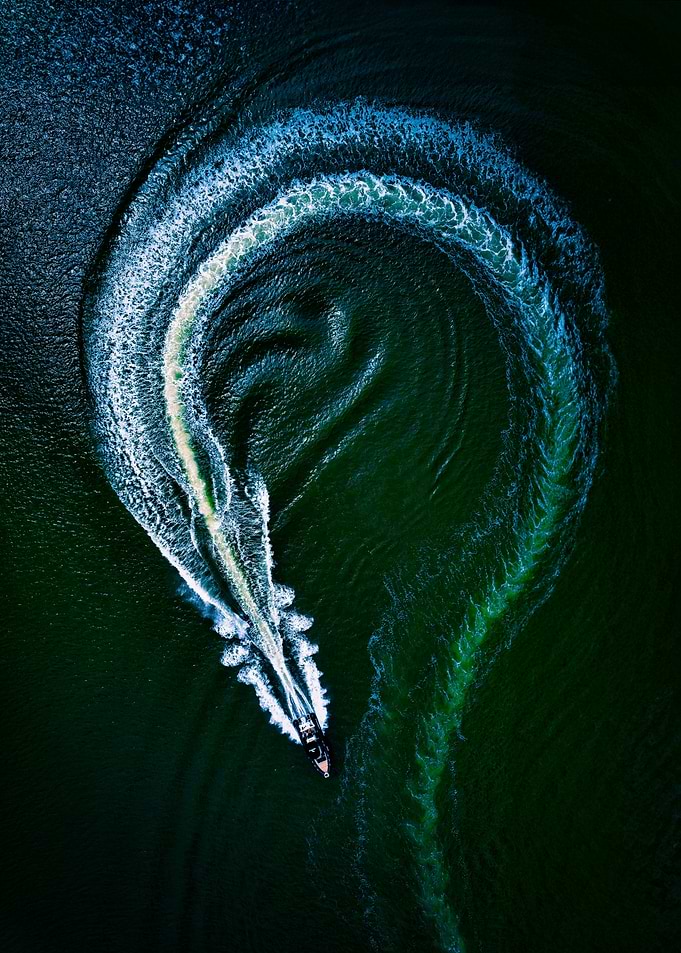 Boat Turning in Dark Green Water