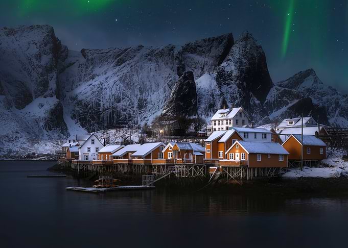 Winter Village Under Aurora Borealis