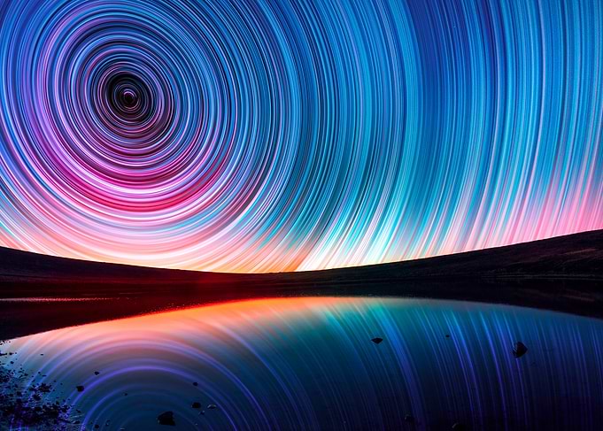 Star Trails Over Water Reflection
