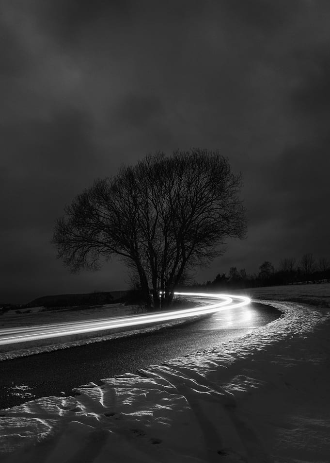 Monochrome Winter Road with Light Trails
