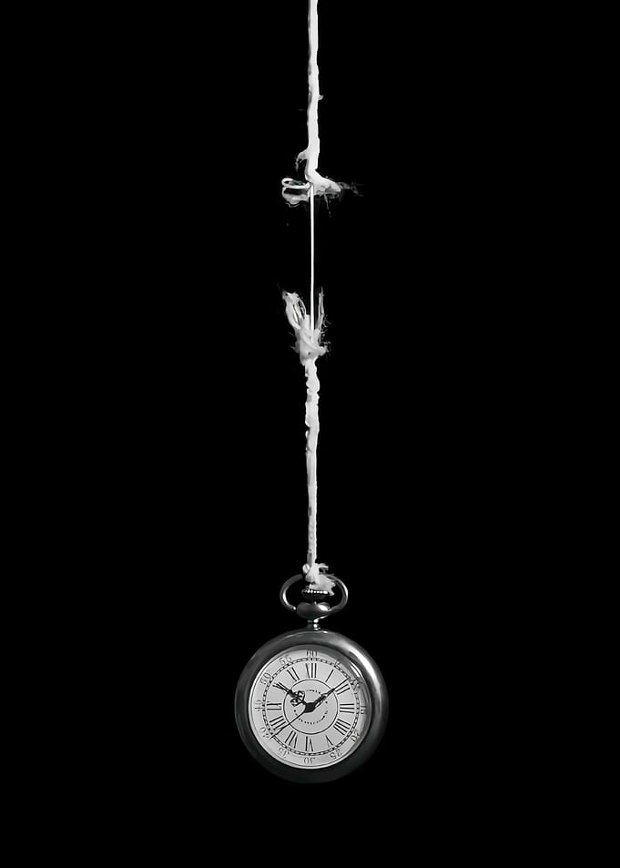 Pocket Watch Hanging by a Thread