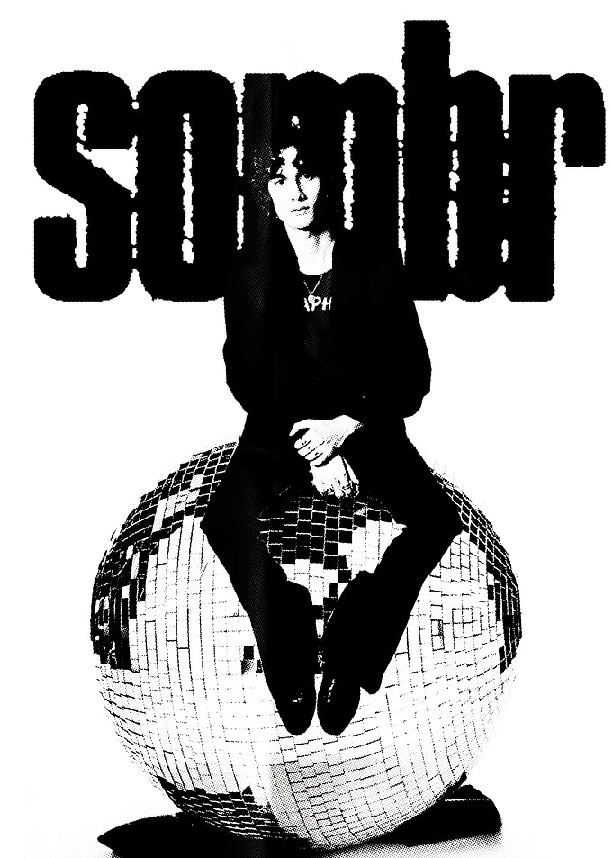 Sombr sitting on a disco ball