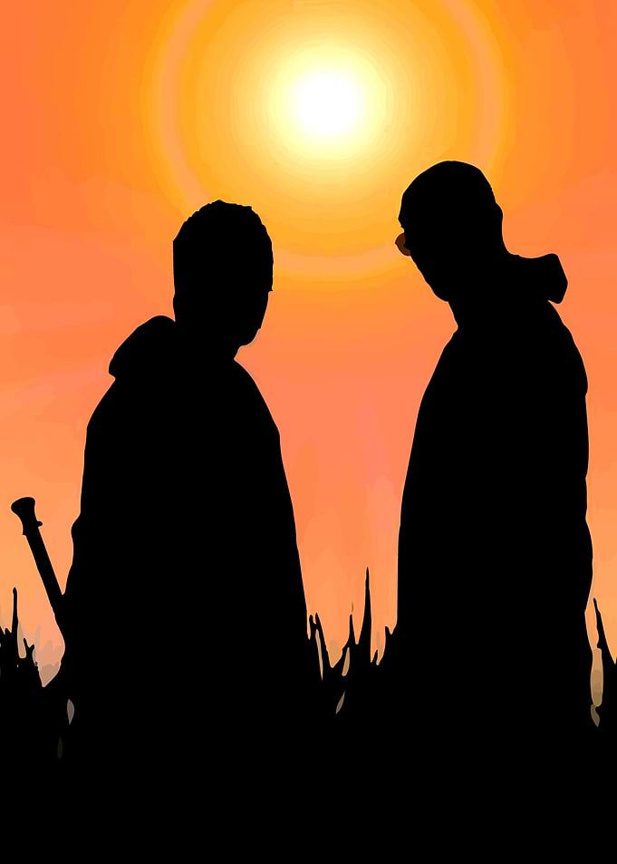 Silhouette of two people at sunset