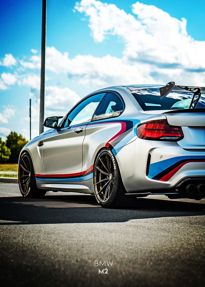 Silver BMW M2 with racing stripes Poster
