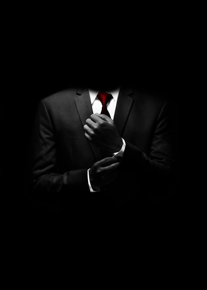 Man in Suit Adjusting Cufflinks