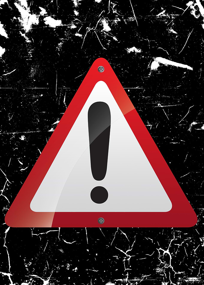 Warning Sign on Grunge Background