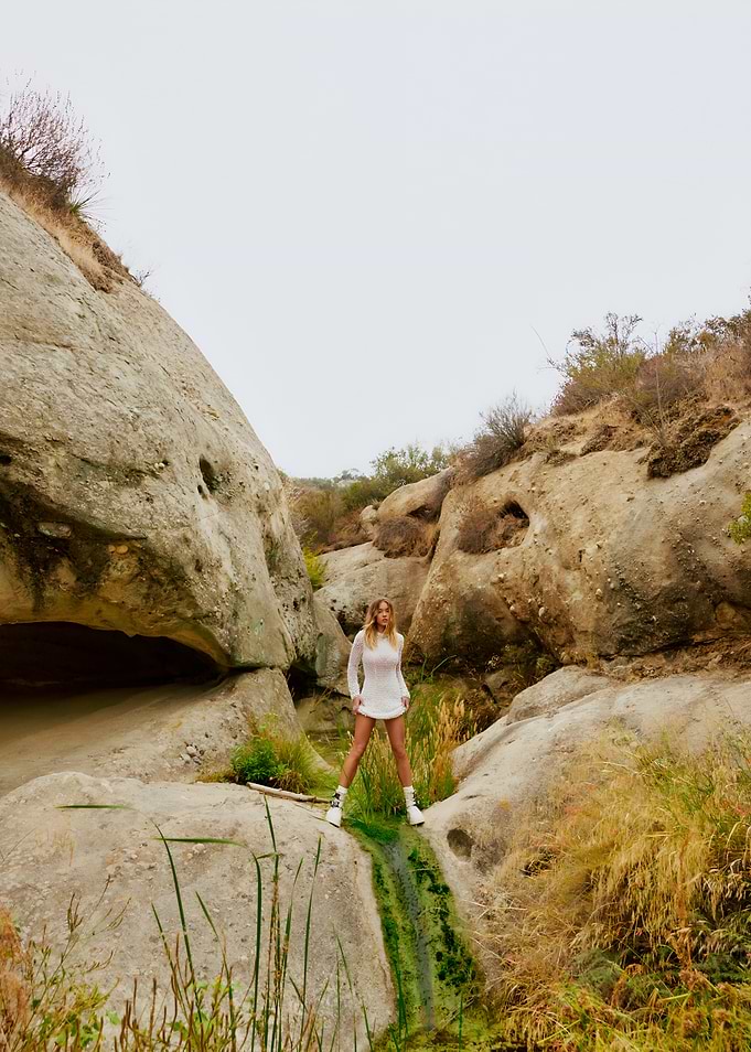 Woman in White Dress, Rocky Landscape