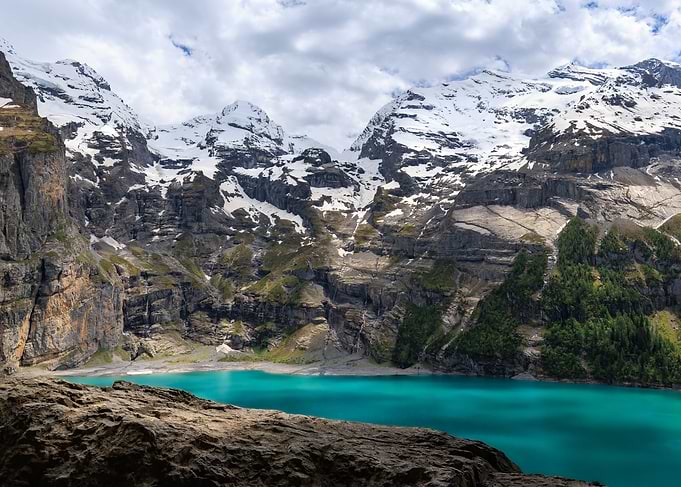 Turquoise Lake Surrounded by Snowy Mountains