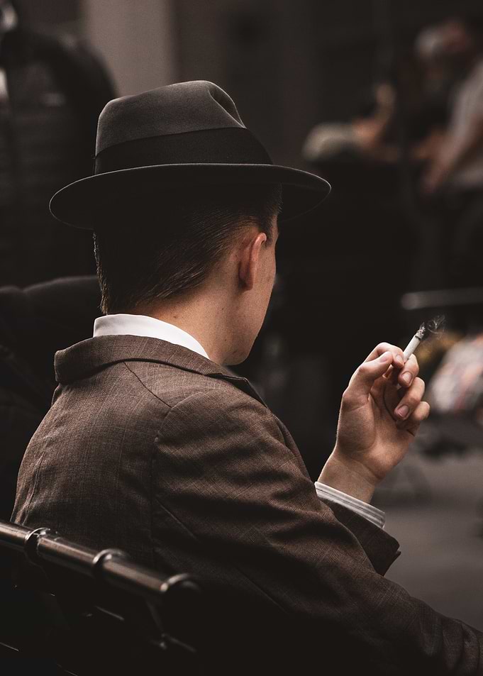 Man in Hat Smoking Cigarette