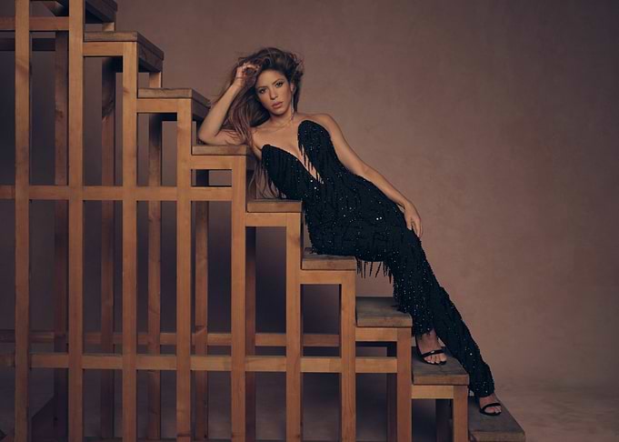Shakira in Black Dress on Stairs