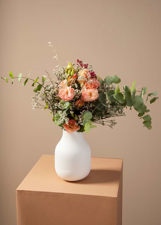 Floral arrangement in white vase