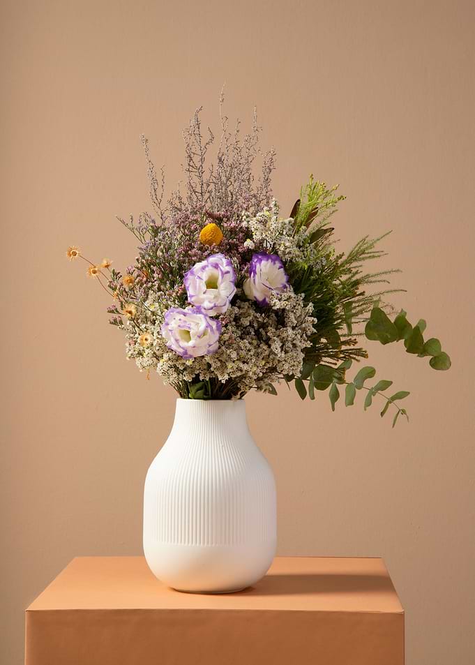 Floral arrangement in white vase