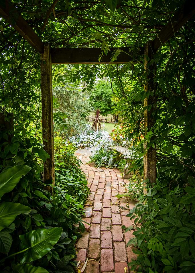 Lush Garden Path Through Wooden Archway