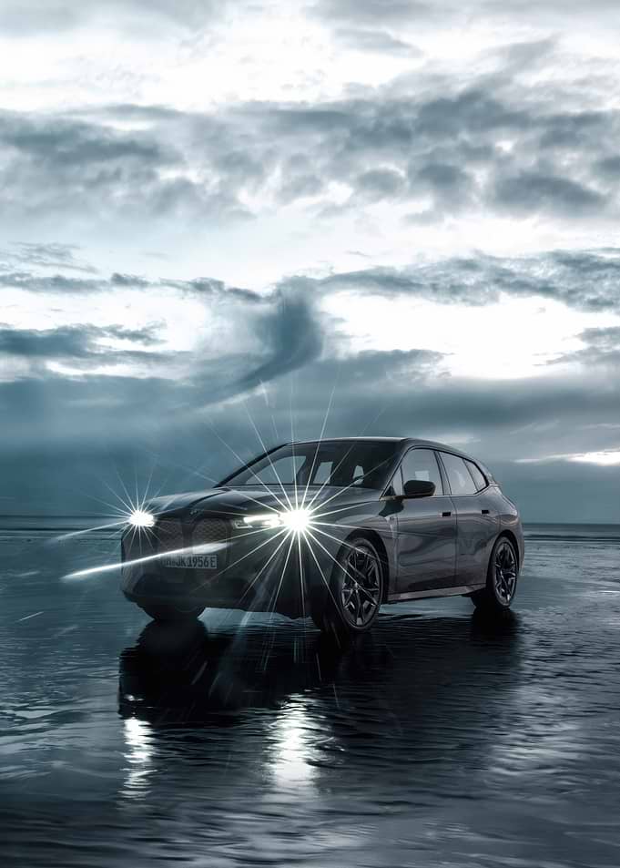 BMW iX electric car on beach