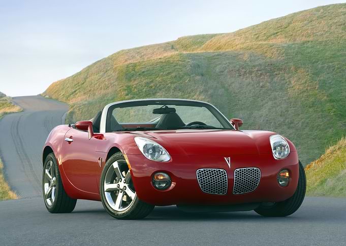 Red Pontiac Solstice Convertible on Road