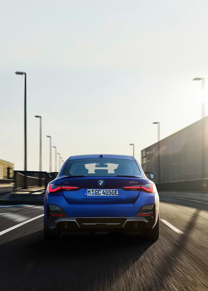 Blue BMW i4 on the road