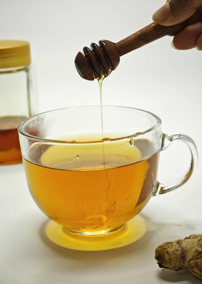 Honey being poured into a cup