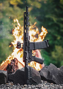 Black AR-15 Rifle with Fire Background