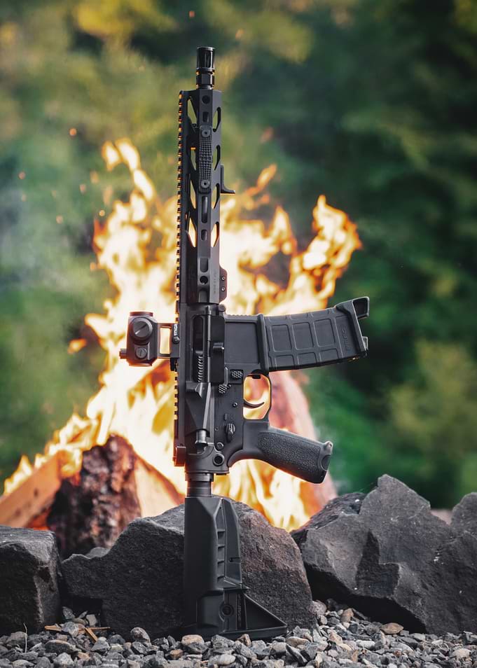 Black AR-15 Rifle with Fire Background