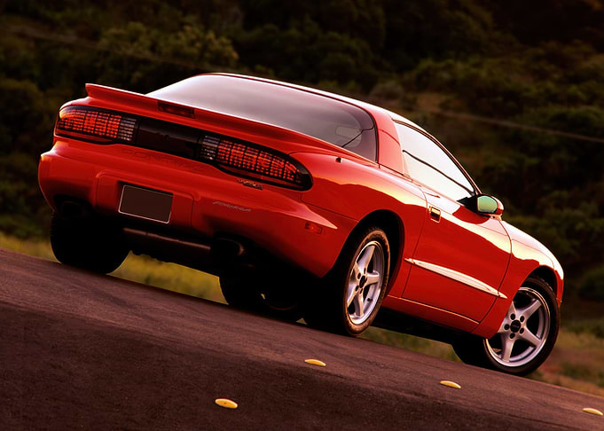 Red Pontiac Firebird on Road