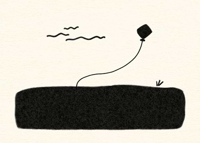 Kite flying over a dark field