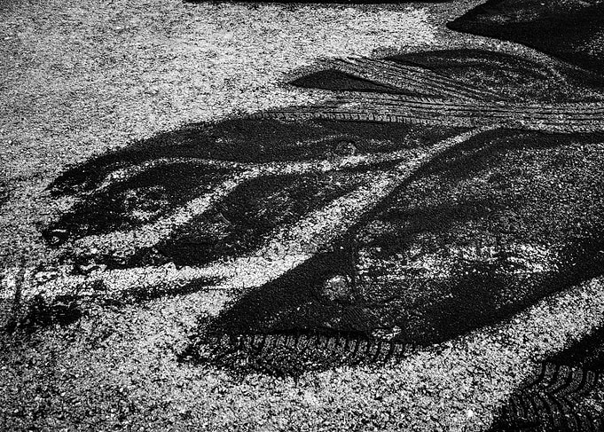 Black and White Tire Tracks on Asphalt