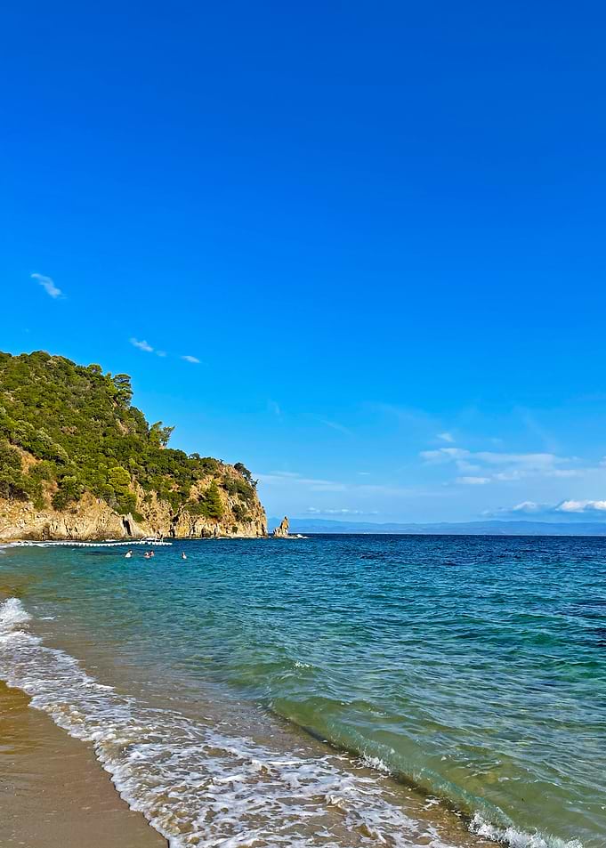 Beach with Cliff and Blue Sky