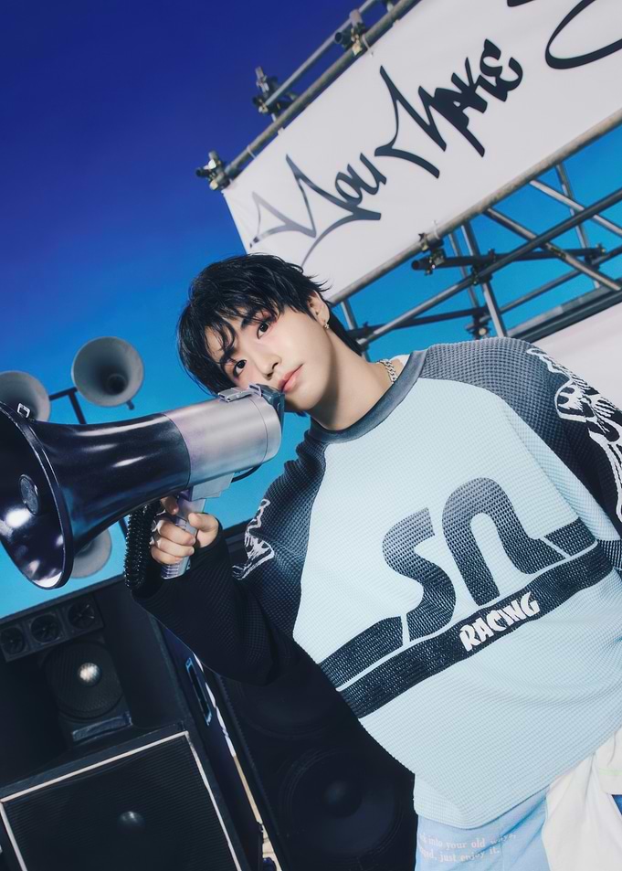 Young man with megaphone, blue sky