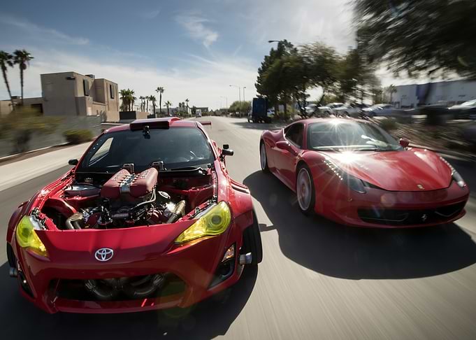 Red Toyota and Ferrari on Road