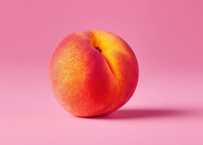 Single Peach on Pink Background