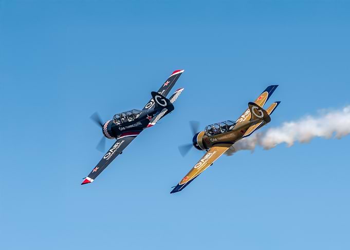 Two Yak-52 Aerobatics in Blue Sky