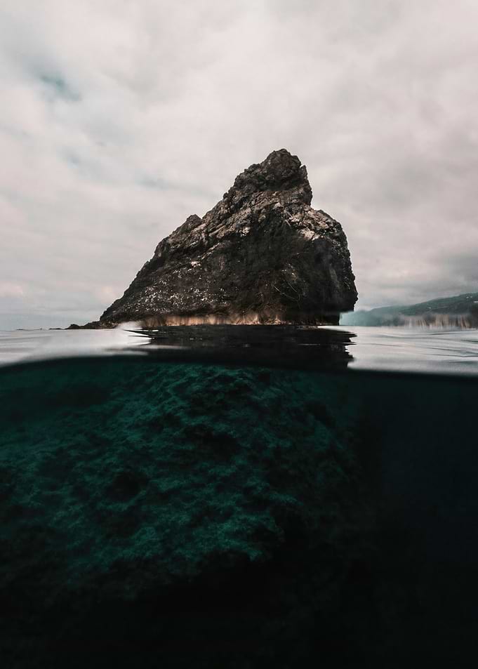 Island Rock Formation Half Underwater View