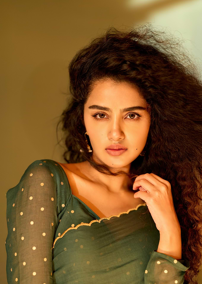 Portrait of a woman with curly hair anupama