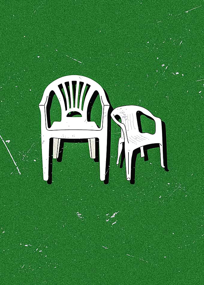 Two White Plastic Chairs on Green