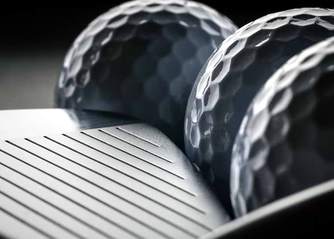 Golf Balls and Iron Club Face Close-Up