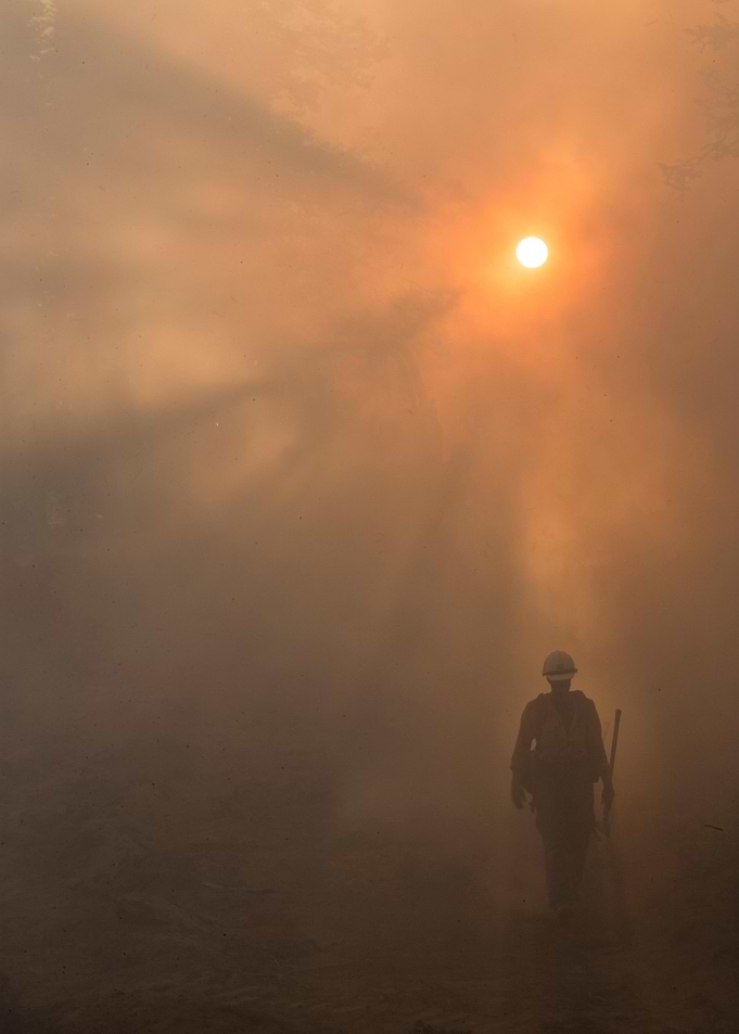 Firefighter in Smoke at Sunset