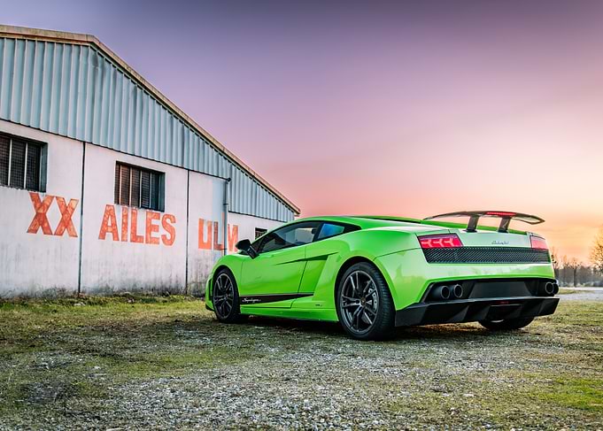 Green Lamborghini Gallardo superleggera near old building