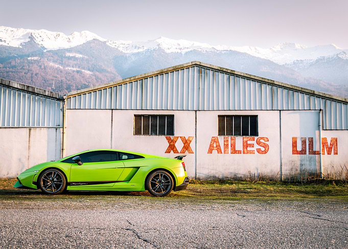 Green Lamborghini in front of building