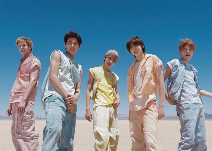 Five young men in desert landscape