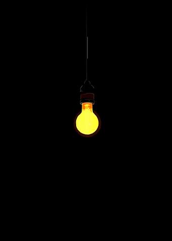 Glowing Light Bulb on Black Background
