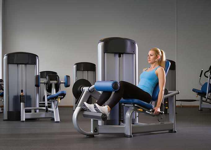 Woman using leg extension machine
