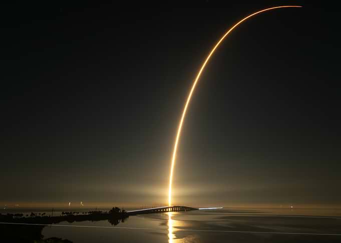 Rocket Launch at Night over Bridge
