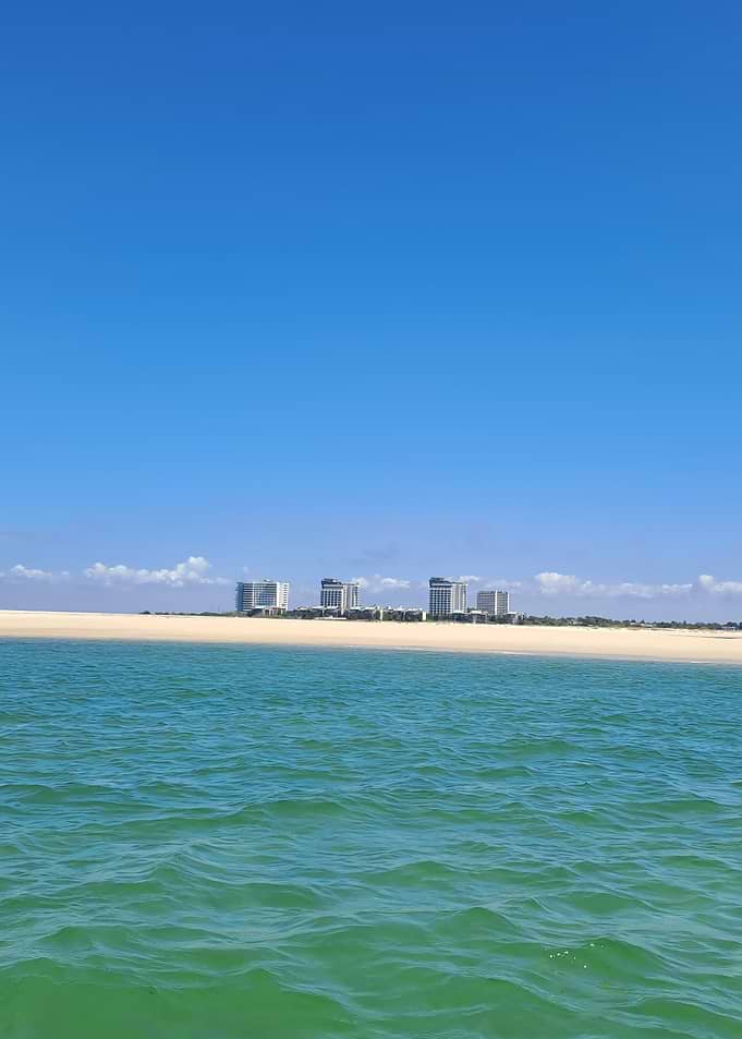 Beachfront buildings under a clear sky