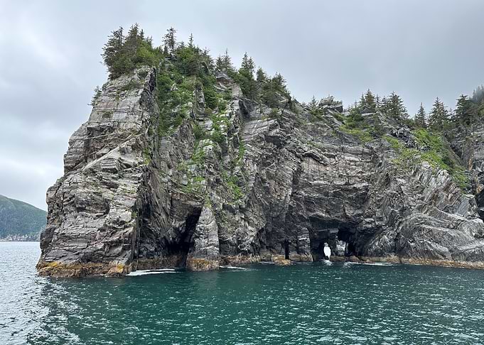 Alaskan Rocky Island with Arches in Ocean