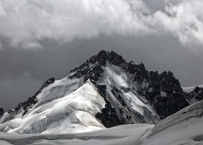 Snowy Mountain Peak Under Cloudy Sky
