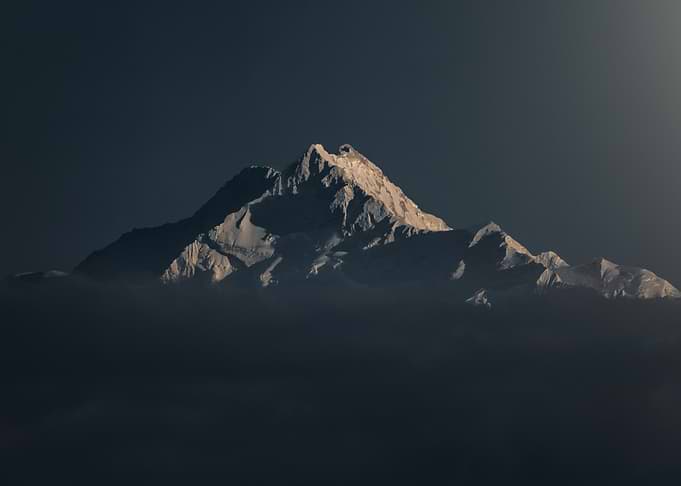 Snowy Mountain Peak Above the Clouds