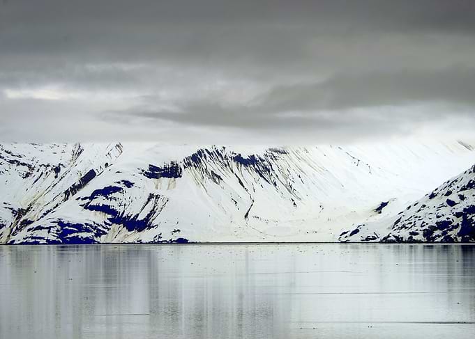 Snowy Mountains Reflecting in Water